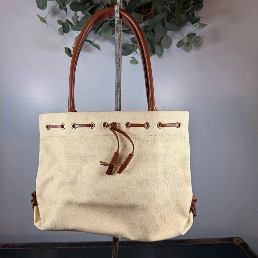 Dooney and Bourke Beige Canvas and Leather Signature Tassel Tote Handbag